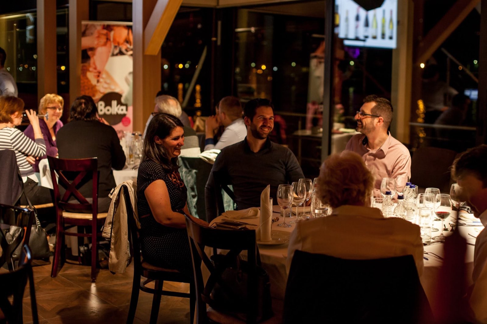 Guests at their tables on deck in the evening